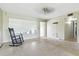 Bright living area with large window, exposed floors, and ceiling fan at 6196 Mayberry Ave, North Port, FL 34287