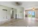Open-concept living area with exposed flooring and a ceiling fan at 6196 Mayberry Ave, North Port, FL 34287