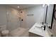 Modern bathroom featuring marble tile, a double sink vanity with granite counters, and updated fixtures at 7052 Legion St, Port Charlotte, FL 33981