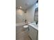 Modern bathroom with a tub, marble tile surround, a granite-top single sink vanity, and sleek black fixtures at 7052 Legion St, Port Charlotte, FL 33981
