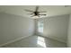 Simple bedroom featuring wood-look floors, a ceiling fan, and a window with outdoor views at 7052 Legion St, Port Charlotte, FL 33981