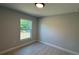 Comfortable bedroom with wood-look floors, a window with a garden view, and freshly painted walls at 7052 Legion St, Port Charlotte, FL 33981