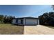 Charming single-story home featuring a brick driveway, a two-car garage, and a well-maintained front lawn at 7052 Legion St, Port Charlotte, FL 33981