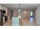 Bright, open-concept kitchen featuring a center island, stainless appliances, and sleek white cabinetry at 7052 Legion St, Port Charlotte, FL 33981