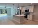 Modern kitchen featuring stainless steel appliances, white cabinets, and a central island with a sink at 7052 Legion St, Port Charlotte, FL 33981