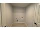 A modern laundry room with shelving and ample space for appliances and laundry tasks at 7052 Legion St, Port Charlotte, FL 33981