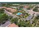Aerial view of condo building with a community pool and playground, convenient parking, and close proximity to shops at 8098 Moonstone Dr # 17-203, Sarasota, FL 34233