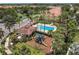 An aerial view of the community pool, playground, surrounding landscaping and attractive buildings in this community at 8098 Moonstone Dr # 17-203, Sarasota, FL 34233