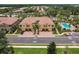 An aerial view of the community and pool, convenient parking, lush landscaping and attractive two-story buildings at 8098 Moonstone Dr # 17-203, Sarasota, FL 34233