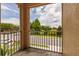 Relax on this balcony with views of the street, landscaping, and a pond at 8098 Moonstone Dr # 17-203, Sarasota, FL 34233