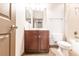 Bathroom featuring a dark wood vanity, shower-tub combo, and neutral tile flooring at 8098 Moonstone Dr # 17-203, Sarasota, FL 34233