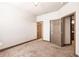 Bedroom featuring neutral walls and carpet with a door leading to a bathroom for added convenience at 8098 Moonstone Dr # 17-203, Sarasota, FL 34233