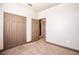Bedroom with a large double closet, carpet, and neutral walls providing a comfortable living space at 8098 Moonstone Dr # 17-203, Sarasota, FL 34233