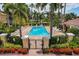An inviting community pool, surrounded by palm trees and lounge chairs for relaxation and enjoyment by the residents at 8098 Moonstone Dr # 17-203, Sarasota, FL 34233