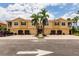 Inviting townhome complex with garages, manicured landscaping, and palm trees creating a desirable curb appeal at 8098 Moonstone Dr # 17-203, Sarasota, FL 34233