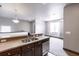 Modern kitchen featuring stainless steel appliances, granite counters, and a double basin sink at 8098 Moonstone Dr # 17-203, Sarasota, FL 34233