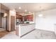 Kitchen area features stainless appliances, wood cabinetry, and large pantry at 8098 Moonstone Dr # 17-203, Sarasota, FL 34233