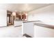 Open-concept living area leading to a modern kitchen with stainless steel appliances and dark wood cabinets at 8098 Moonstone Dr # 17-203, Sarasota, FL 34233