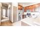 Kitchen area features stainless appliances, wood cabinetry, and tile flooring at 8098 Moonstone Dr # 17-203, Sarasota, FL 34233