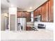 Close up of kitchen featuring stainless appliances, wood cabinetry, and double sink at 8098 Moonstone Dr # 17-203, Sarasota, FL 34233