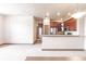 Bright, open-concept living space with stainless steel appliances, dark wood cabinets, and sleek finishes at 8098 Moonstone Dr # 17-203, Sarasota, FL 34233
