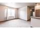 Bright living room featuring neutral walls and carpet, and a large window at 8098 Moonstone Dr # 17-203, Sarasota, FL 34233