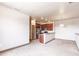 Open floor plan with view of kitchen featuring stainless appliances and raised breakfast bar at 8098 Moonstone Dr # 17-203, Sarasota, FL 34233