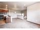 Open floor plan with view of kitchen, stainless appliances, and stairway to upper level at 8098 Moonstone Dr # 17-203, Sarasota, FL 34233