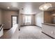 Bright living room features neutral walls and carpet with a sliding glass door to the balcony at 8098 Moonstone Dr # 17-203, Sarasota, FL 34233