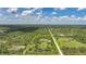 Stunning aerial perspective highlighting the expansive property, pond, and tranquil wooded surroundings at 8312 Acorn Blvd, Punta Gorda, FL 33982