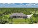 Beautiful single-story home with metal roof, set on a sprawling lot with lush landscaping at 8312 Acorn Blvd, Punta Gorda, FL 33982