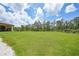Lush green backyard with manicured lawn, offering ample space for outdoor activities and relaxation at 8312 Acorn Blvd, Punta Gorda, FL 33982