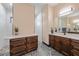 Modern bathroom showcasing double sinks, rich wood cabinets, and a stunning walk-in shower at 8312 Acorn Blvd, Punta Gorda, FL 33982