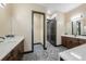 Bathroom with double vanities and a seamless door leading to the walk-in closet at 8312 Acorn Blvd, Punta Gorda, FL 33982