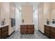 Elegant bathroom with double vanity, wooden cabinets, and a large walk-in shower at 8312 Acorn Blvd, Punta Gorda, FL 33982
