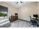 Bedroom with desk, chair, dresser, and a view of the greenery outside the window at 8312 Acorn Blvd, Punta Gorda, FL 33982