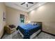Bedroom featuring a chair, queen bed with a blue patterned comforter, and a ceiling fan at 8312 Acorn Blvd, Punta Gorda, FL 33982