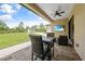 Charming covered patio with a ceiling fan and outdoor seating, overlooking a spacious yard and a shed at 8312 Acorn Blvd, Punta Gorda, FL 33982