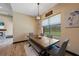 Cozy dining room featuring a wooden table, bench seating, and backyard view at 8312 Acorn Blvd, Punta Gorda, FL 33982