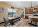 Dining area adjacent to the kitchen featuring a rustic table, bench seating, and a view to the backyard at 8312 Acorn Blvd, Punta Gorda, FL 33982
