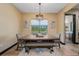 Dining room featuring a rustic table, bench seating, and a view to the backyard at 8312 Acorn Blvd, Punta Gorda, FL 33982