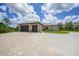Well-manicured home featuring a circular driveway leading to a spacious two-car garage and ample parking at 8312 Acorn Blvd, Punta Gorda, FL 33982