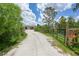 Long gravel driveway leading up to a beautifully landscaped home and property at 8312 Acorn Blvd, Punta Gorda, FL 33982