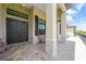 Home exterior featuring double doors, stone columns, and a stone accent wall, with tasteful outdoor seating at 8312 Acorn Blvd, Punta Gorda, FL 33982