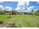 Spacious front yard with lush green grass and a charming exterior view of the beautiful single-story home at 8312 Acorn Blvd, Punta Gorda, FL 33982