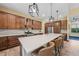 Open kitchen featuring an island with barstool seating, stone countertops, and wood cabinets at 8312 Acorn Blvd, Punta Gorda, FL 33982