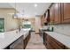 Well-equipped kitchen featuring stainless steel appliances, an island with sink, and a view to the dining area at 8312 Acorn Blvd, Punta Gorda, FL 33982
