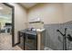 Well-equipped laundry room featuring modern appliances and a convenient dog-washing station with stylish tile work at 8312 Acorn Blvd, Punta Gorda, FL 33982