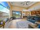 Inviting living room showcasing a stone fireplace, comfortable seating, and sliding glass doors to the backyard at 8312 Acorn Blvd, Punta Gorda, FL 33982