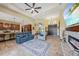 Open-concept living room with modern furniture, a fireplace, and seamless access to the kitchen area at 8312 Acorn Blvd, Punta Gorda, FL 33982